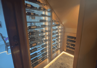 Elegant wine storage with illuminated racks showcasing a variety of wine bottles.