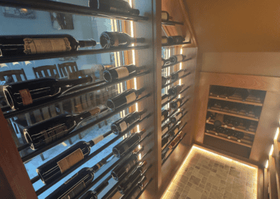 Elegant wine display wall at Example Co showcasing a variety of wine bottles in a cozy setting.