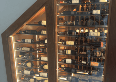 Elegant wine cellar with wooden racks filled with various wine bottles.