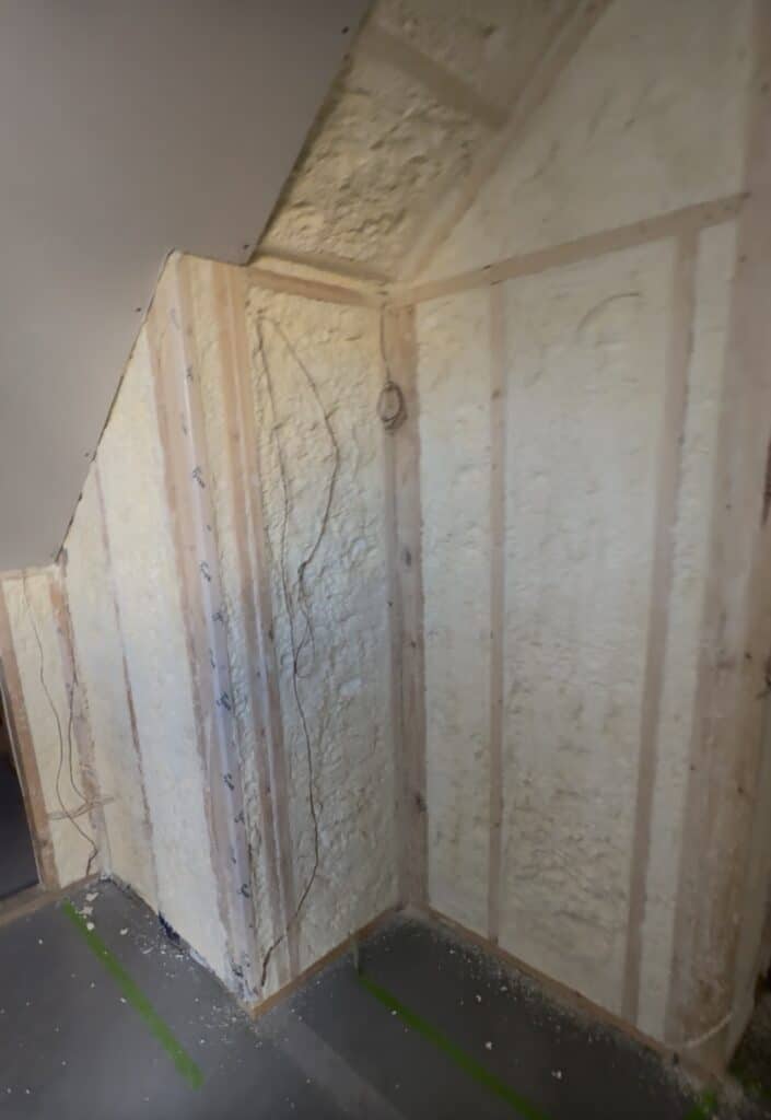 Closed cell spray foam installed flush to the stud face in a wine cellar under construction